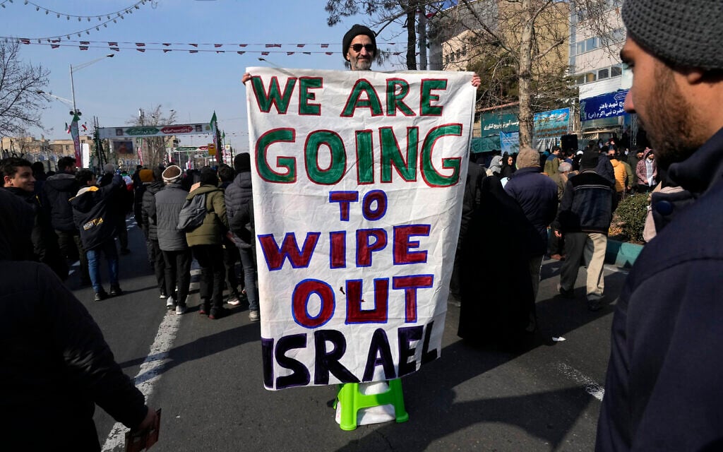 An Iranian demonstrator holds an anti-Israeli banner during a rally commemorating anniversary of 1979 Islamic Revolution, February 10, 2025. (AP Photo/Vahid Salemi)