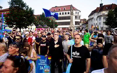 Supporters of the far-right AfD party sing the national anthem as they attend an election campaign rally of the party for the upcoming state elections in Suhl, Germany, August 13, 2024. (AP Photo/Markus Schreiber, File)
