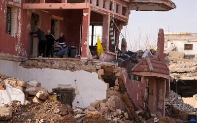 Lebanese citizens check the destruction on their house caused by the war between Hezbollah and Israel, in their hometown Khiam, southern Lebanon, February 17, 2025. (AP Photo/Hassan Ammar)