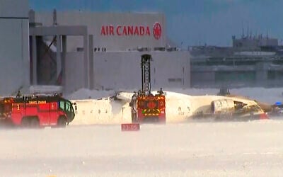 This image taken from video provided by CTV shows emergency crews responding at Toronto Pearson Airport after a plane crash, February 17, 2025. (CTV via AP)