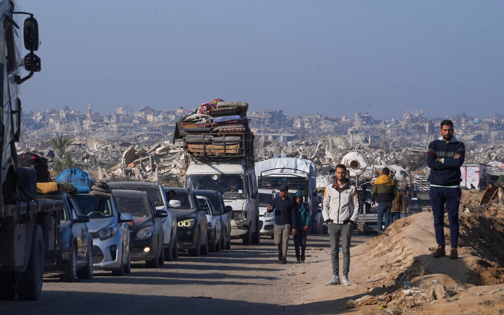 Displaced Palestinians, traveling in vehicles, wait to cross through a security checkpoint at the Netzarim Corridor as they make their way from central Gaza to the northern Gaza Strip, February 18, 2025. (AP Photo/Abdel Kareem Hana)