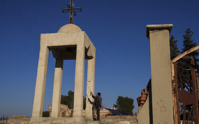 Ishaq Nissan, a Syriac Orthodox Christian, rings the church bell in the northeastern Syrian village of Tel Tal, currently controlled by the US-backed, Kurdish-led Syrian Democratic Forces, January 27, 2025. (AP/Bernat Armangue)