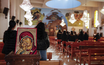 Syrian Christians gather for Sunday Mass at the Church of Saint George in the town of Maaloula, Syria, January 12, 2025. (AP Photo/Omar Sanadiki)
