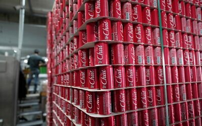 Cans of Chat Cola-branded aluminum cans are stacked, separated by cardboard pallets, on the production line at the Palestinian company's bottling plant in the West Bank city of Salfit, February 13, 2025. (AP Photo/Nasser Nasser)