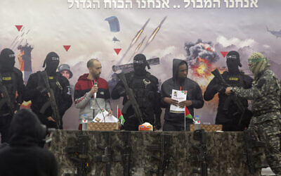 Israeli hostages Tal Shoham left, and Avera Mengisto are put on stage by Hamas in Rafah, southern Gaza Strip, on Saturday, Feb. 22, 2025. (AP/Jehad Alshrafi)