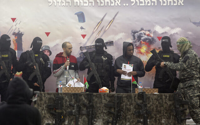 Israeli hostages Tal Shoham left, and Avera Mengisto are put on stage by Hamas in Rafah, southern Gaza Strip, on Saturday, Feb. 22, 2025. (AP/Jehad Alshrafi)