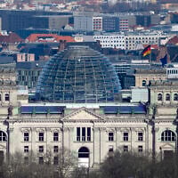 A European and German flags wave at the Reichstag building, the house of German parliament Bundestag at the eve of the national election in Berlin, Germany, Saturday, Feb. 22, 2025. (AP Photo/Markus Schreiber)