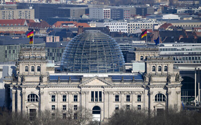 A European and German flags wave at the Reichstag building, the house of German parliament Bundestag at the eve of the national election in Berlin, Germany, Saturday, Feb. 22, 2025. (AP Photo/Markus Schreiber)