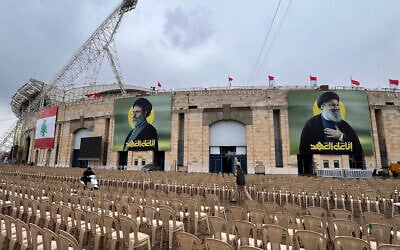 People pass between chairs set up outside Beirut's City Sportive stadium, a day ahead of the funeral procession of Hezbollah leaders Sayyed Hassan Nasrallah and Sayyed Hashem Safieddine, in Beirut, Lebanon, Saturday, Feb. 22, 2025. (AP Photo/Hussein Malla)