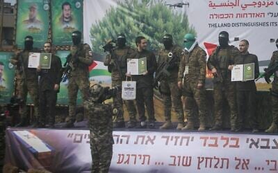 Israeli hostages, from left to right, Eliya Cohen, Omer Shem and Omer Wenkert, are told to show Hamas issued certificates by before being handed over to the Red Cross in Nuseirat, central Gaza Strip, Saturday, February 22, 2025. (AP/Jehad Alshrafi)