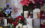 Candles and a photo of Pope Francis are seen in front of the Agostino Gemelli Polyclinic, in Rome, February 22, 2025, where the Pontiff has been hospitalized since Friday, February 14.(AP Photo/Alessandra Tarantino)