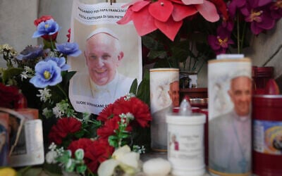Candles and a photo of Pope Francis are seen in front of the Agostino Gemelli Polyclinic, in Rome, February 22, 2025, where the Pontiff has been hospitalized since Friday, February 14.(AP Photo/Alessandra Tarantino)