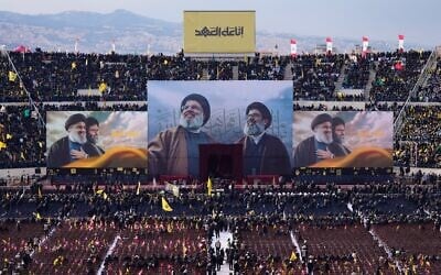 Images depicting the Hezbollah's former leader Hassan Nasrallah, center left, and his late cousin and heir-apparent, Hashem Safieddine, are displayed during their funeral ceremony at the Sports City Stadium in Beirut, Lebanon, February 23, 2025. (AP Photo/Hassan Ammar)