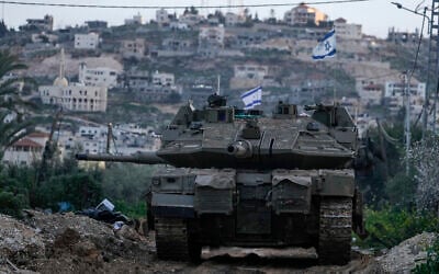 An Israeli tank drives towards the Jenin camp in the West Bank, February 23, 2025. (AP Photo/Majdi Mohammed)