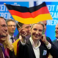 Leader of the far-right AfD Alice Weidel waves a German flag at the AfD party headquarters in Berlin on February 23, 2025, after the German national election. (Michael Probst/AP)