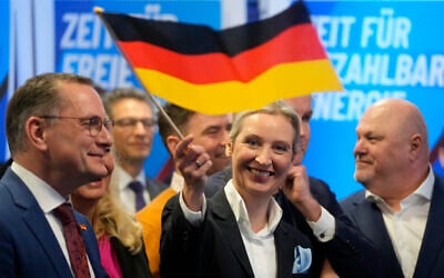 Leader of the far-right AfD Alice Weidel waves a German flag at the AfD party headquarters in Berlin on February 23, 2025, after the German national election. (Michael Probst/AP)