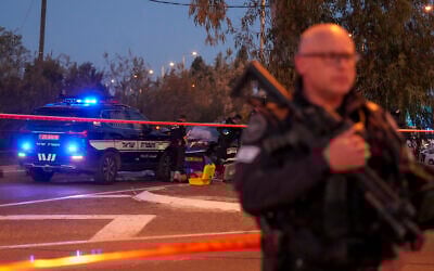 Israeli police officers examine the body of a terror suspect who rammed his car into a highway bus stop near Gan Shmuel, Israel, on Thursday, February 27, 2025. (AP/Ariel Schalit)