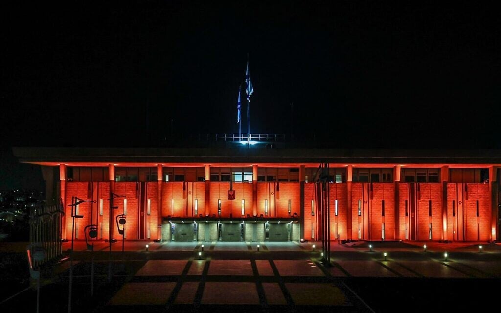 The Knesset lights up in orange in memory of Shiri, Ariel and Kfir Bibas, who were murdered in captivity in Gaza, on February 25, 2025. (Dani Shem Tov/Knesset Spokesman)