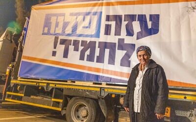 Head of the Nachala settlements advocacy organization Daniella Weiss  stands by a sign declaring "Gaza is ours forever," in the southern city of Sderot, December 26, 2024. (Yossi Aloni/Flash90)