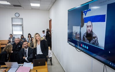 Wasim a-Sayed, an ISIS-affiliated terrorist from Hebron who murdered three people in Jerusalem, is sentenced to three life sentences and another 40-year prison sentence, and is seen on a screen at the District Court in Jerusalem, February 3, 2025. (Chaim Goldberg/Flash90)