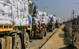 Trucks loaded with humanitarian aid at the Kerem Shalom crossing between Israel and the Gaza Strip, February 4, 2025. (Abed Rahim Khatib/Flash90)