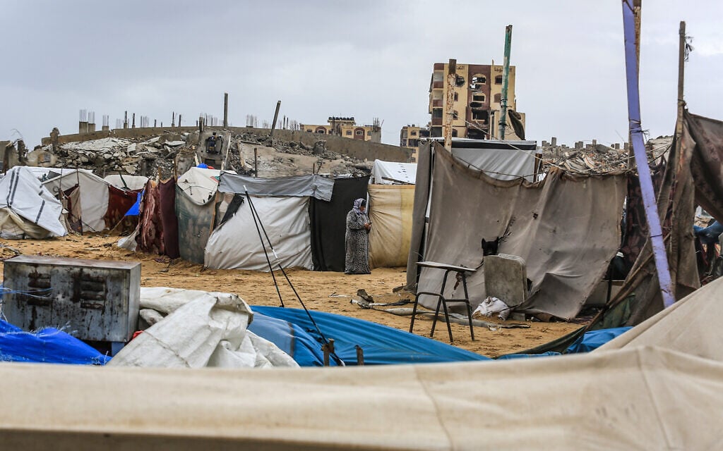 Displaced Palestinians shelter in destroyed and flooded tents amid stormy weather in Deir al-Balah, in the southern Gaza Strip, February 6, 2025. (Abed Rahim Khatib/Flash90)