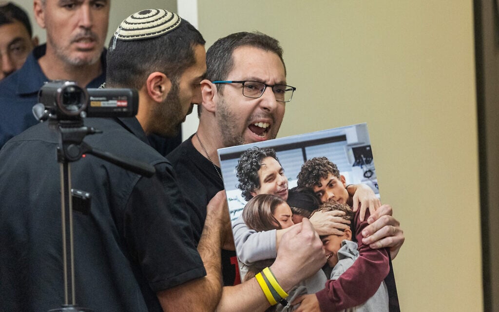 Eyal Calderon, cousin of released hostage Ofer Calderon, reacts as Finance Minister Bezalel Smotrich leads a faction meeting of his Religious Zionism party at the Knesset in Jerusalem, February 10, 2025. (Yonatan Sindel/Flash90)
