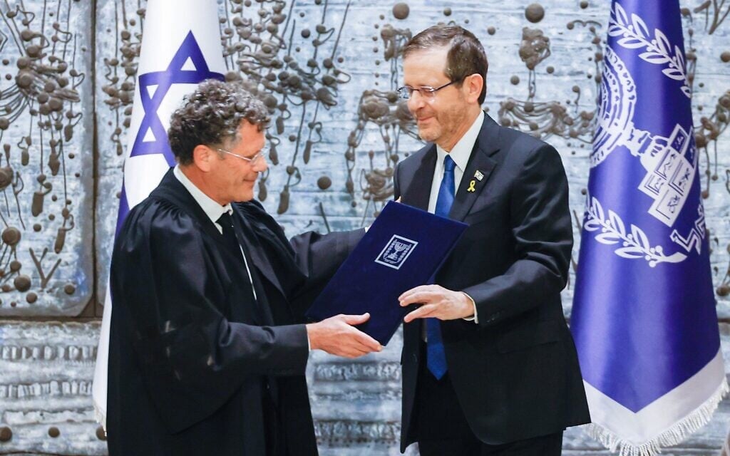 Supreme Court President Isaac Amit, left, is sworn in during an inauguration ceremony at the President's Residence in jerusalem, alongside President Isaac Herzog, on February 13, 2025. (Yonatan SIndel/FLASH90)