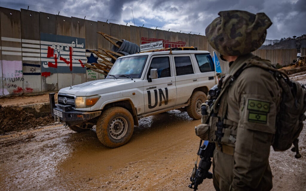 An Israeli soldier look while UN peacekeepers patrol in Kfar Kila, in southern Lebanon, February 13, 2025. (Yonatan Sindel/Flash90)