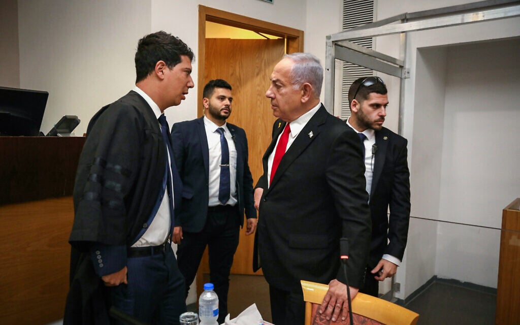 Prime Minister Benjamin Netanyahu, right, and his lawyer Amit Hadad arrive at the courtroom at the Tel Aviv District Court for the 10th day of the premier's testimony in his corruption trial, February 17, 2025. (Gideon Markowicz/POOL)