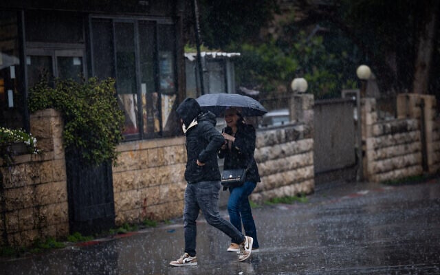People walk in the rain during a winter day in Jerusalem, on February 20, 2025. (Yonatan Sindel/Flash90) People walk in the rain during a winter day in Jerusalem, on February 20, 2025. (Yonatan Sindel/Flash90)