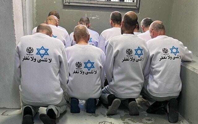 The Israel Prison Service dresses Palestinian prisoners set for release in shirts featuring its logo, a Star of David and the sentence in Arabic: 'We will not forget or forgive,' February 15, 2025. (Israel Prison Service)