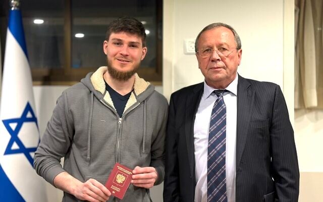 Russian-Israeli citizen Alexander Troufanov (L), just released from 498 days of captivity in the Gaza Strip, meets with Russian Ambassador to Israel Anatoly Viktorov (R), February 15, 2025. (Russian Embassy to Israel via X)