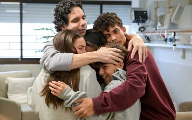 Released hostage Ofer Calderon, top left, reunites with his children Rotem, Gaya, Erez and Sahar on February 1, 2025. Erez and Sahar were also abducted on October 7, 2023 and were freed in November 2023. (Ma'ayon Taof / GPO)