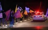 This handout photo shows Israelis lining a highway in southern Israel as police transport the remains of slain hostages to the national forensic center in Tel Aviv, February 27, 2025. (Israel Police)