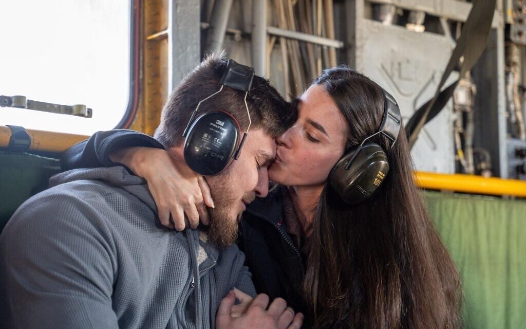 Freed hostage Sasha Troufanov, left, reunites with his girlfriend Sapir Cohen in an Israeli Air Force helicopter on the way from the Gaza border area to Sheba-Tel Hashomer Medical Center near Tel Aviv, February 15, 2025. (IDF)