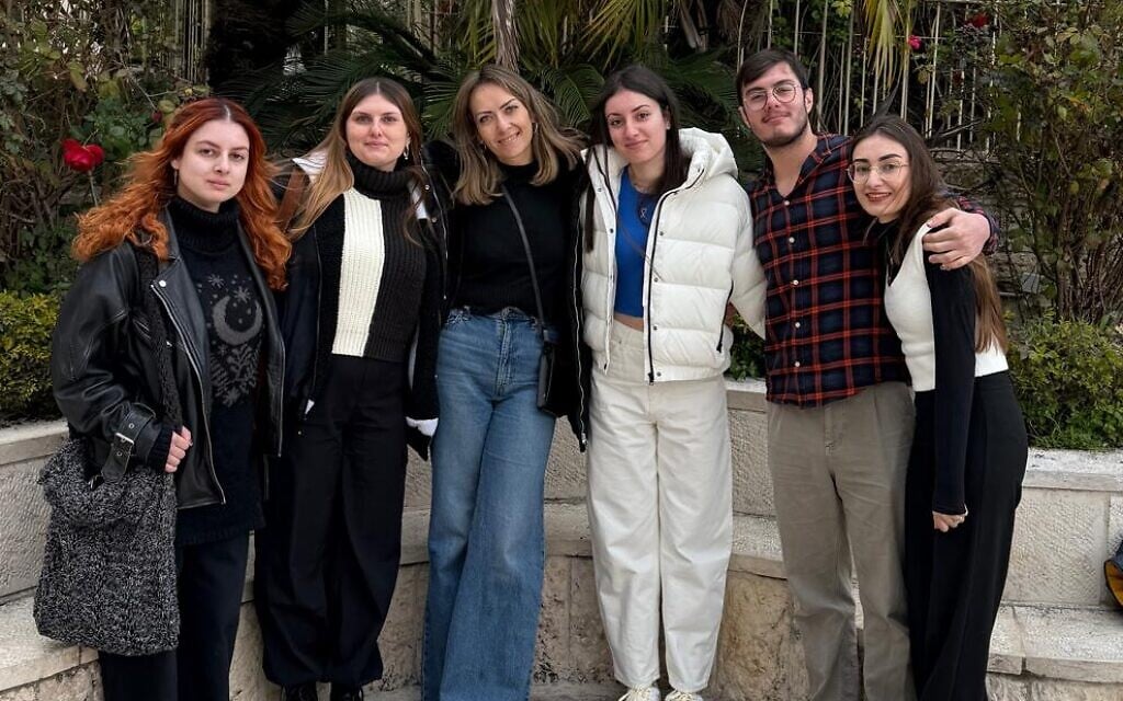 Released hostage Karina Ariev, third from right, and her sister, Sasha Ariev, far right, with cousins after Karina's release on January 25, 2025 (Courtesy)
