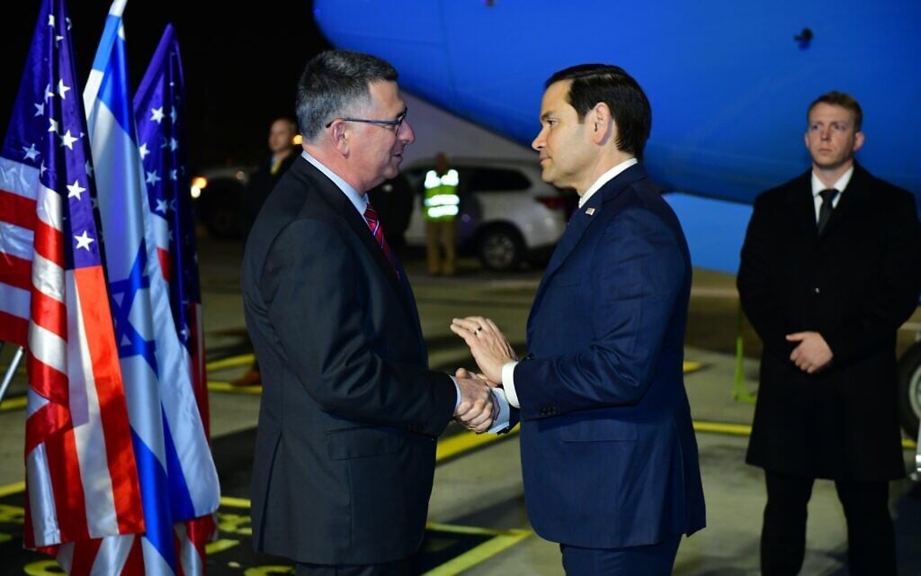 Foreign Minister Gideon Sa'ar, left, greets US Secretary of State Marco Rubio at Ben Gurion Airport, February 15, 2025. (Rafi Ben Hakun/GPO)