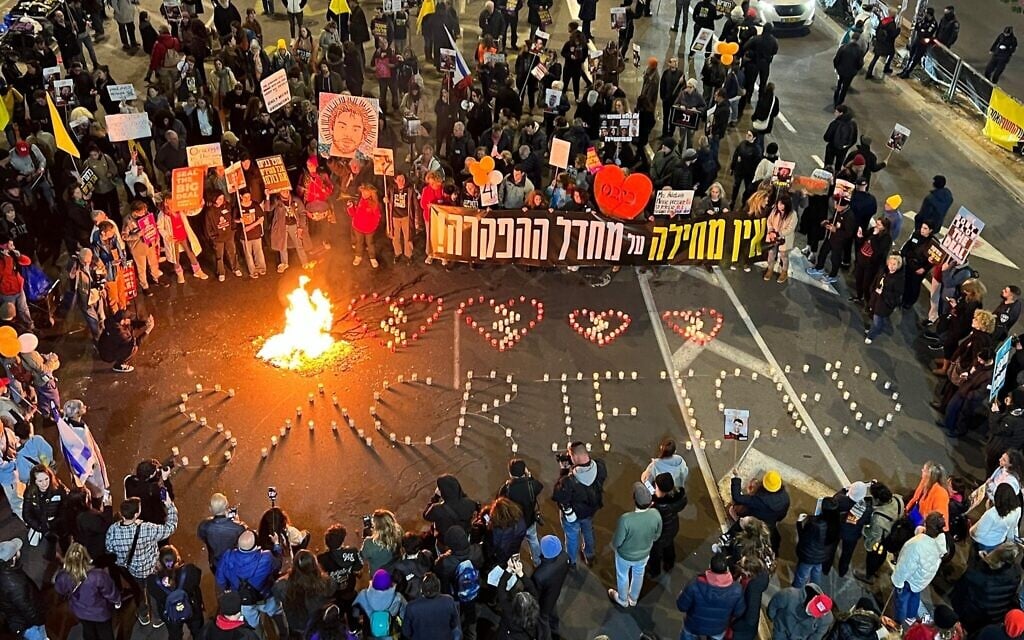 Activists form the word 'Sacrificed' in memorial candles during an event mourning returned hostages from Gaza, at Tel Aviv's Begin Road, February 20, 2025. (Yael Gadot/Pro-Democracy Protest Movement)