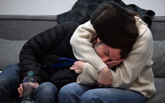 Relatives of hostage Tal Shoham watch his release by the Hamas terror group as they wait at the Rabin Medical Center in Petah Tikva on February 22, 2025 (Haim Zach/GPO)