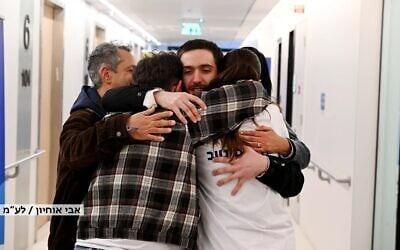 Released hostage Omer Shem Tov reunites with relatives at a hospital in central Israel on February 22, 2025 (Avi Ohiyon / GPO)