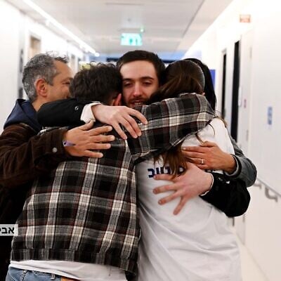 Released hostage Omer Shem Tov reunites with relatives at a hospital in central Israel on February 22, 2025 (Avi Ohiyon / GPO)