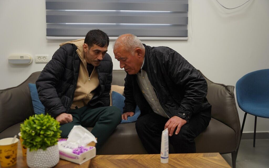 Freed hostage Hisham al-Sayed, left, meets his father at the Re'im facility near Gaza, after being released by Hamas following 10 years in captivity, February 22, 2025. (IDF)