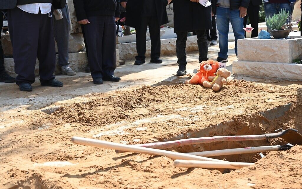 Children's toys next to the grave of Shiri Bibas and sons Ariel and Kfir during the slain hostages' funeral near Kibbutz Nir Oz, February 26, 2025. (Eitan Uner / Hostages and Missing Families Forum)
