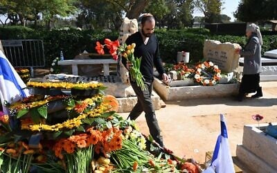 Yarden Bibas carries flowers at the funeral of his wife Shiri and sons Ariel and Kfir, near Kibbutz Nir Oz, February 26, 2025. (Eitan Uner/ Hostages and Missing Families Forum)