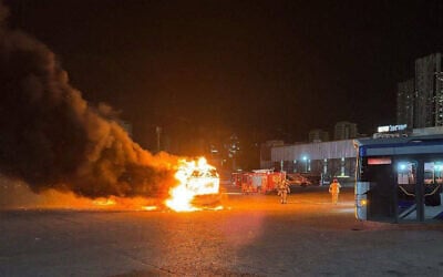 A bus goes up in flames after an explosion at a parking lot in Bat Yam, February 20, 2025. (Screenshot)