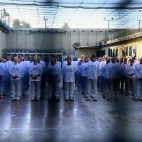 The Israel Prison Service dresses Palestinian prisoners set for release in shirts featuring its logo, a Star of David and the sentence in Arabic: 'We will not forget or forgive,' February 15, 2025. (Israel Prison Service)