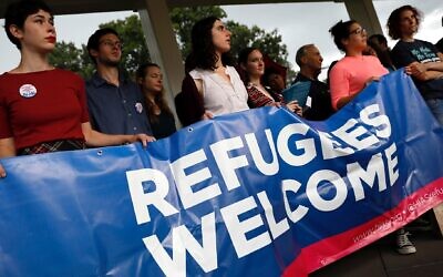 Illustrative: Activists hold a banner during a pro-refugee demonstration organized by HIAS outside the U.S. Capitol, Sept. 14, 2017. (Aaron P. Bernstein/Getty Images via JTA)