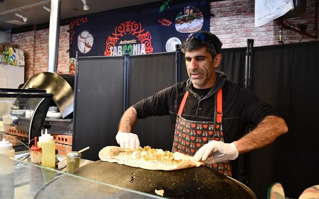 Raif Rashed, an Israeli Druze and the owner of Taboonia, wraps up a pita with labneh in New York City, March 2025. (Jackie Hajdenberg/ JTA) Raif Rashed, an Israeli Druze and the owner of Taboonia, wraps up a pita with labneh in New York City, March 2025. (Jackie Hajdenberg/ JTA)