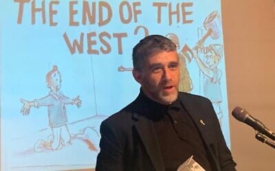 Bereaved father Moshe Shapiro at an event displaying his caricatures sketched before and after his son, Aner Shapiro, was killed on October 7, 2023 (Courtesy)